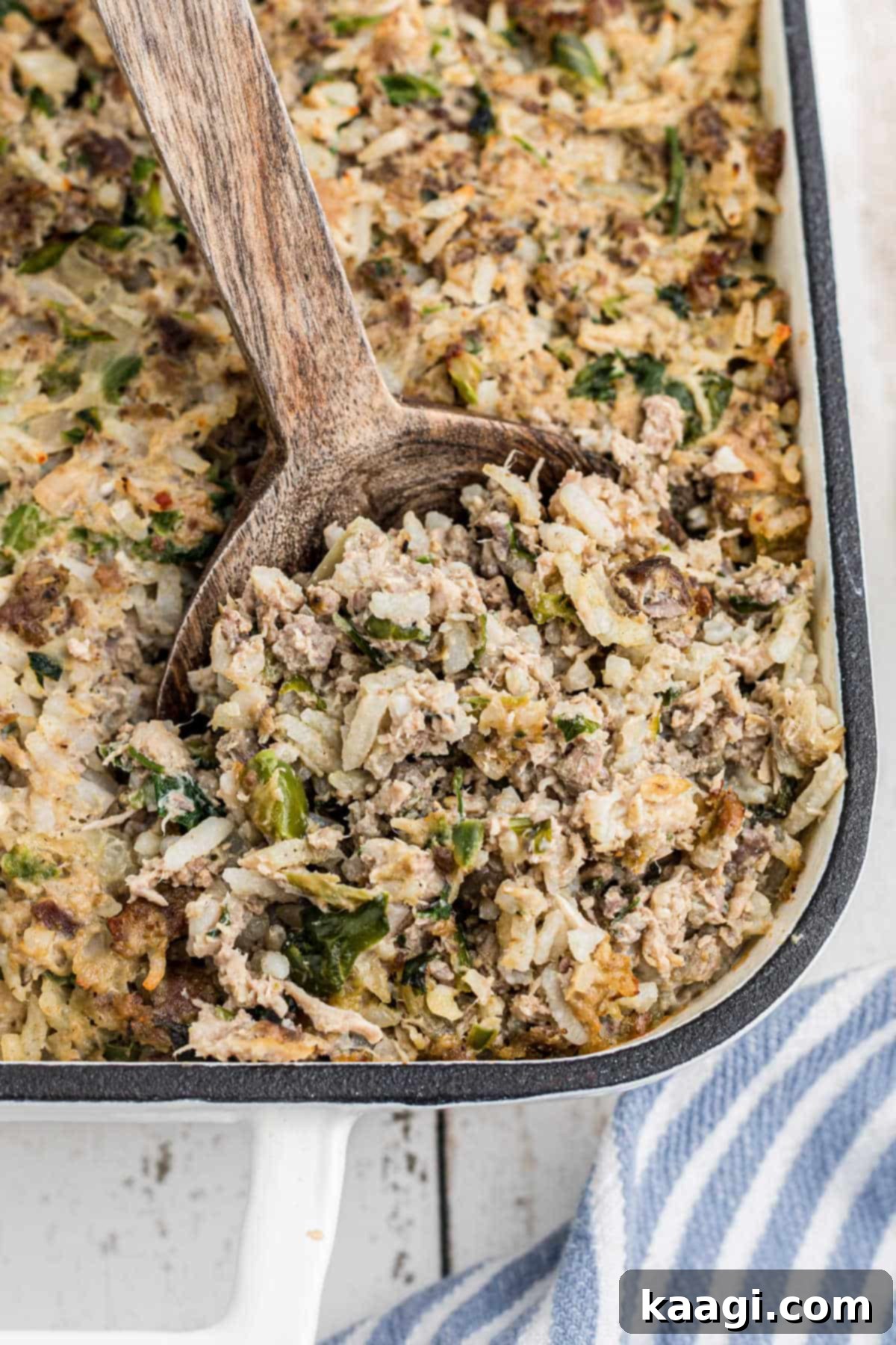 Close up of the corner of a pan of cajun rice dressing, showing its moist texture.