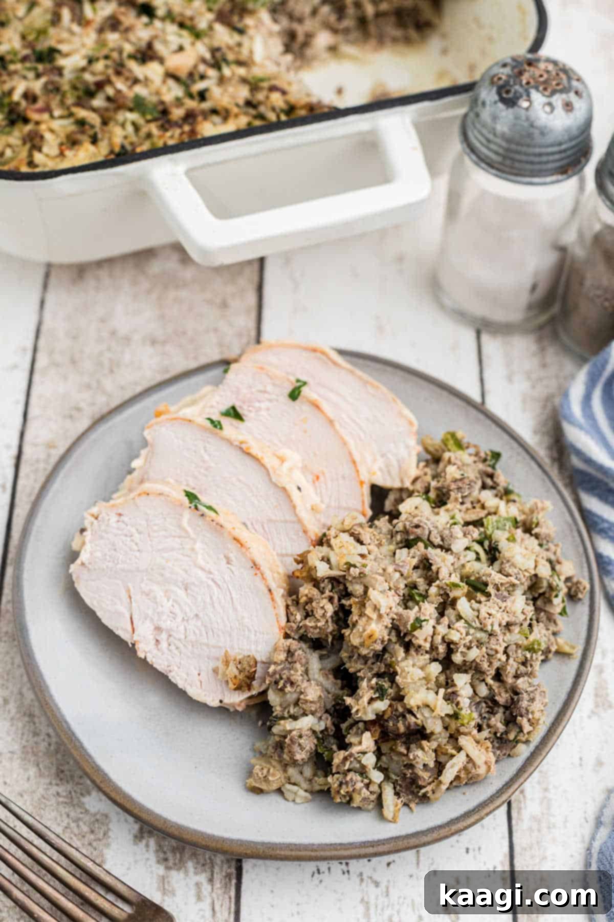 A plated serving of cajun rice dressing with some chicken, ready to be enjoyed.