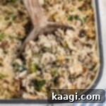 Close up of the corner of a casserole dish of Cajun rice dressing.