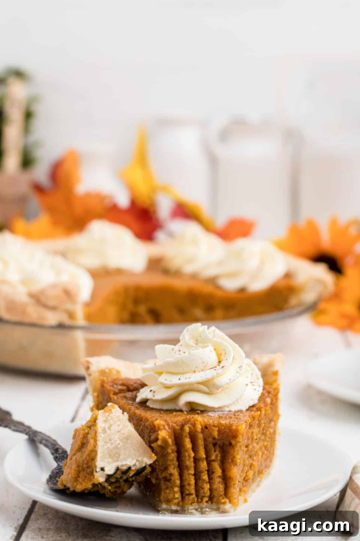 Front on view of a glorious slice of southern sweet potato pie with a little taken out the front, showing its creamy texture.