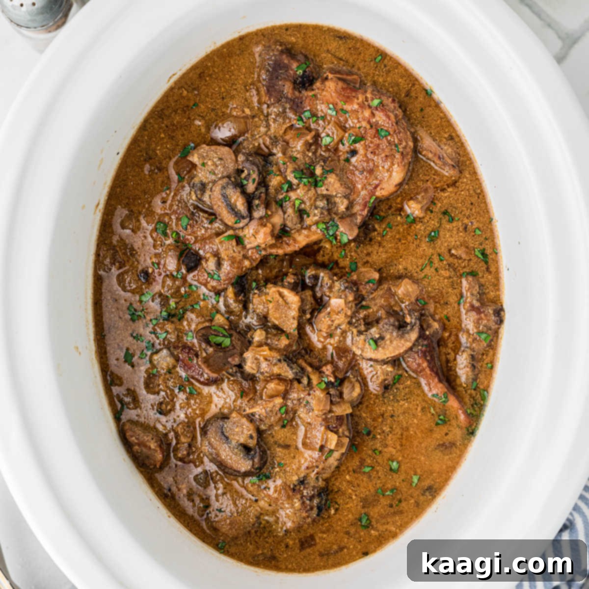 Overhead shot of a slow cooker smothered pork chops recipe.