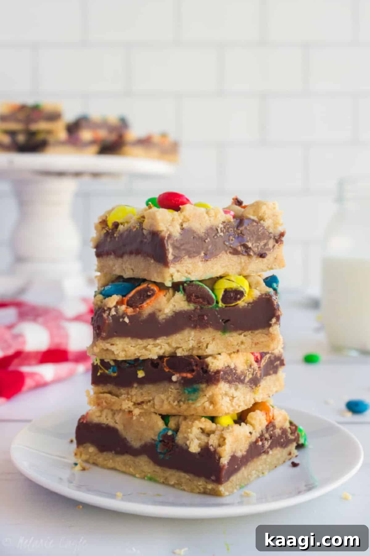 M and M Chocolate Chip Oat Bars 2 M&M Chocolate Oat bars stacked in four, on a plate.