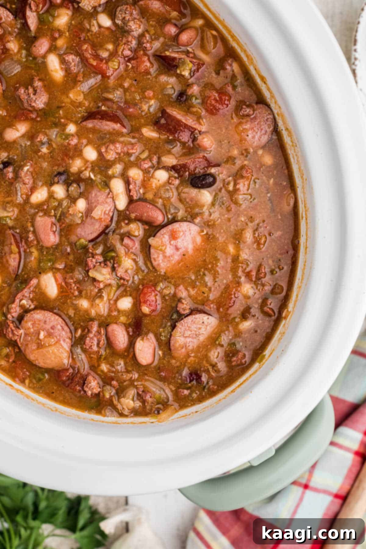 Overhead shot of the finished Slow Cooker Cajun 15 Bean Soup recipe in a slow cooker, showcasing its rich, thick texture and vibrant ingredients.