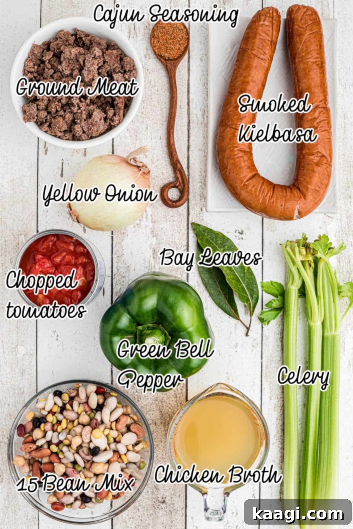 Ingredients laid out for making a Slow Cooker Cajun 15 Bean Soup recipe, including a bag of 15 bean mix, chopped vegetables, and smoked sausage.