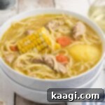 A close up from the side of a dished up bowl of Cuban Chicken Soup.