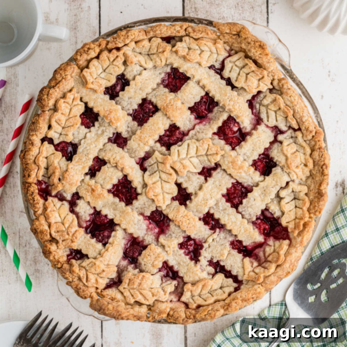 Overhead shot of a pie dish filled with a vibrant Raspberry Pie, perfectly baked and waiting to be sliced.