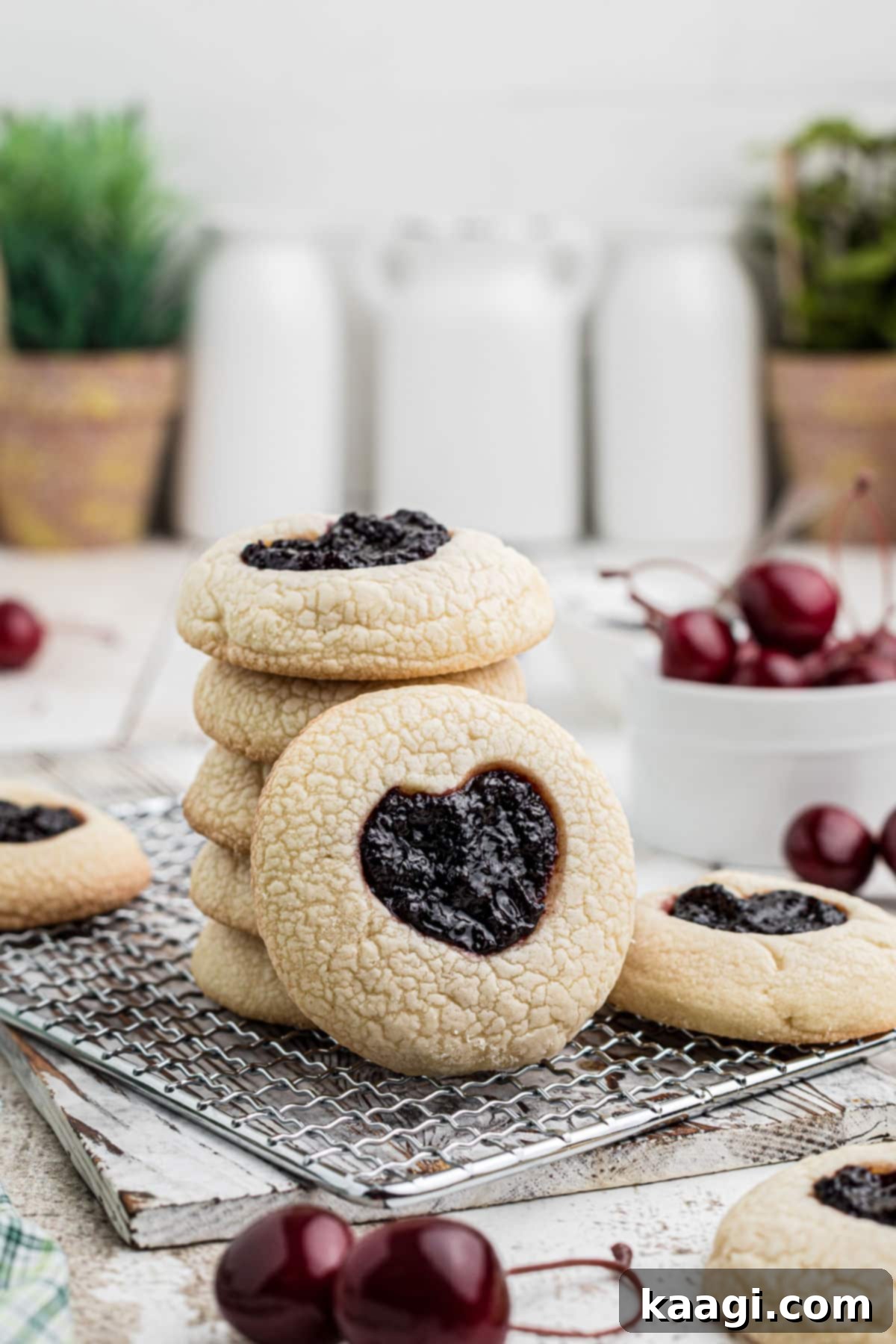 Viral Jam Heart Cookies 4 A charming stack of freshly baked TikTok Jam Heart Cookies, with one standing upright, showcasing their beautiful heart-shaped jam centers.