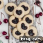 Viral Jam Heart Cookies 6 A wire rack over a piece of white wood with a pile of tiktok jam heart cookies.