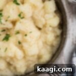 Comforting Potato Stew 7 Close-up shot of a pot of stewed potatoes, highlighting the creamy texture and delicious appearance, ready to be served.