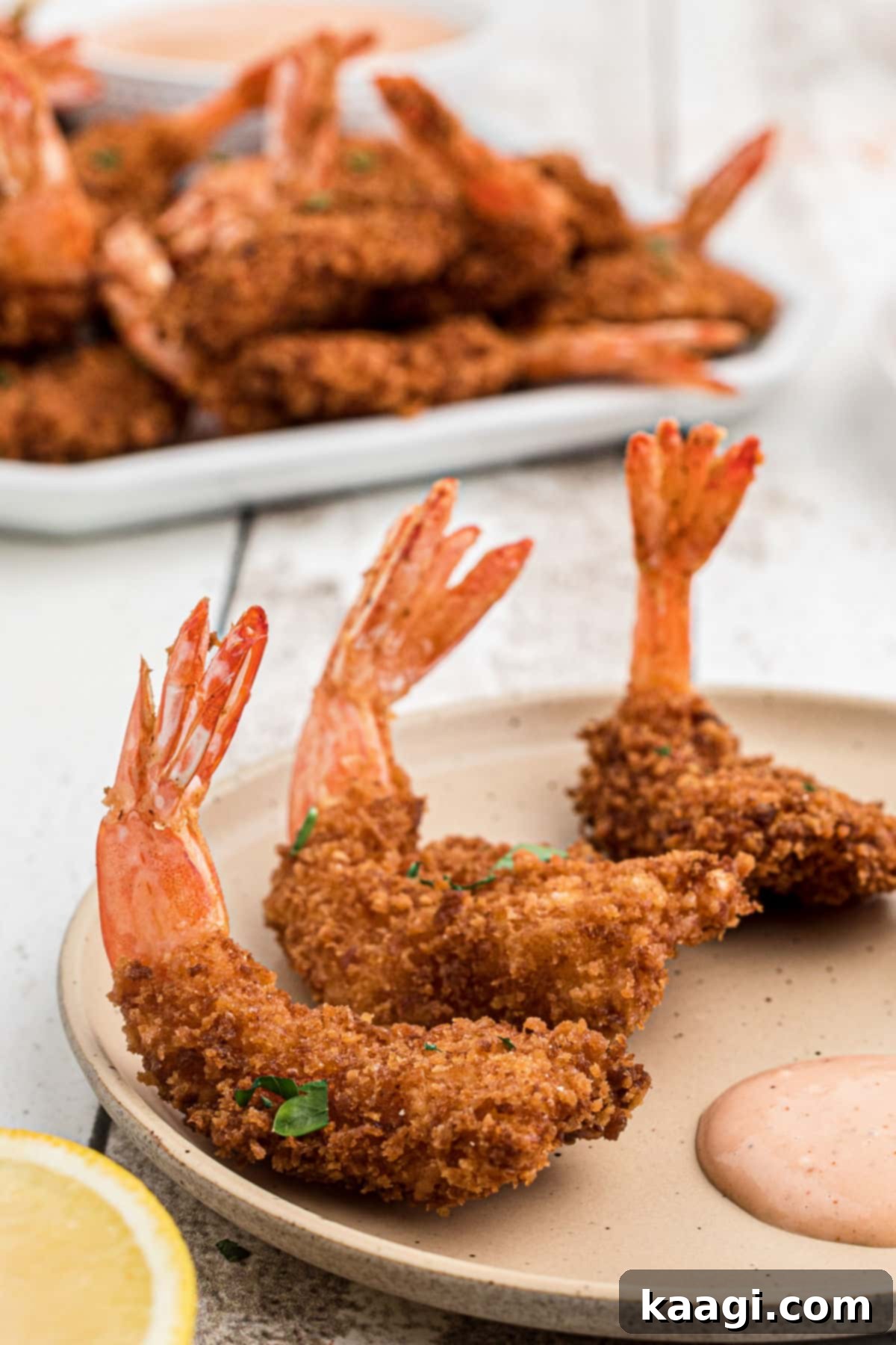 Close up of perfectly fried butterfly shrimp, golden brown and crispy.