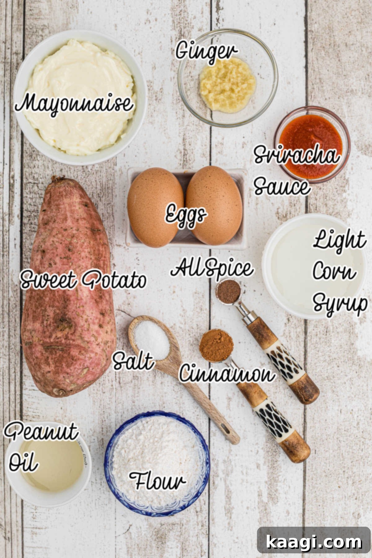 A flat lay shot of all the fresh ingredients laid out, including whole sweet potatoes, fresh ginger, eggs, flour, spice jars, and bottles for the dip ingredients, ready to make sweet potato fritters.