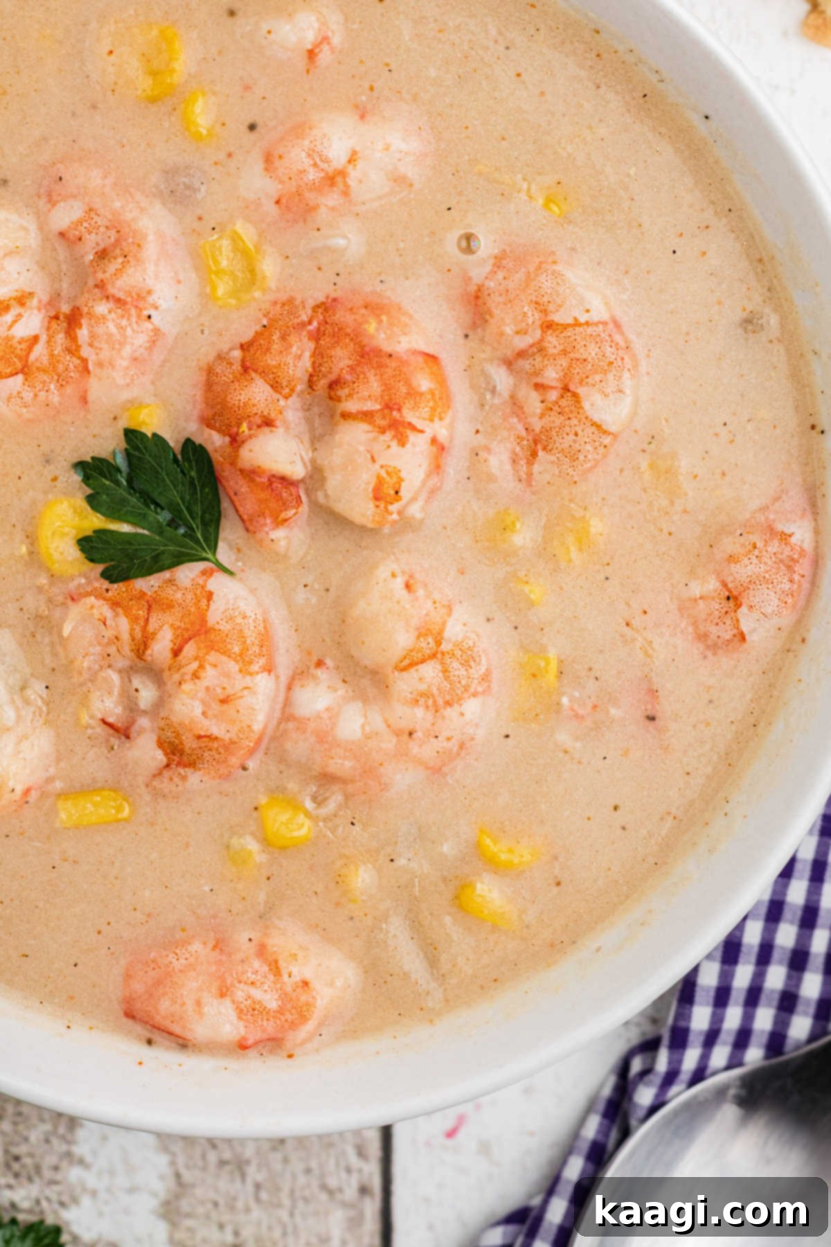 Creamy Shrimp and Sweet Corn Bisque 2 close up of the edge of a bowl of shrimp and corn bisque.