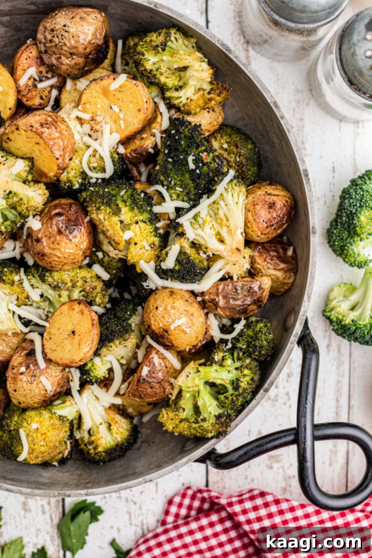 Crispy Roasted Potatoes and Broccoli 2 Overhead close up shot of a pan of roasted potatoes and broccoli, showing golden-brown potatoes and bright green broccoli florets.