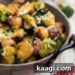 Crispy Roasted Potatoes and Broccoli 6 Close up of a pan of roasted potatoes and broccoli, highlighting their golden crispness.