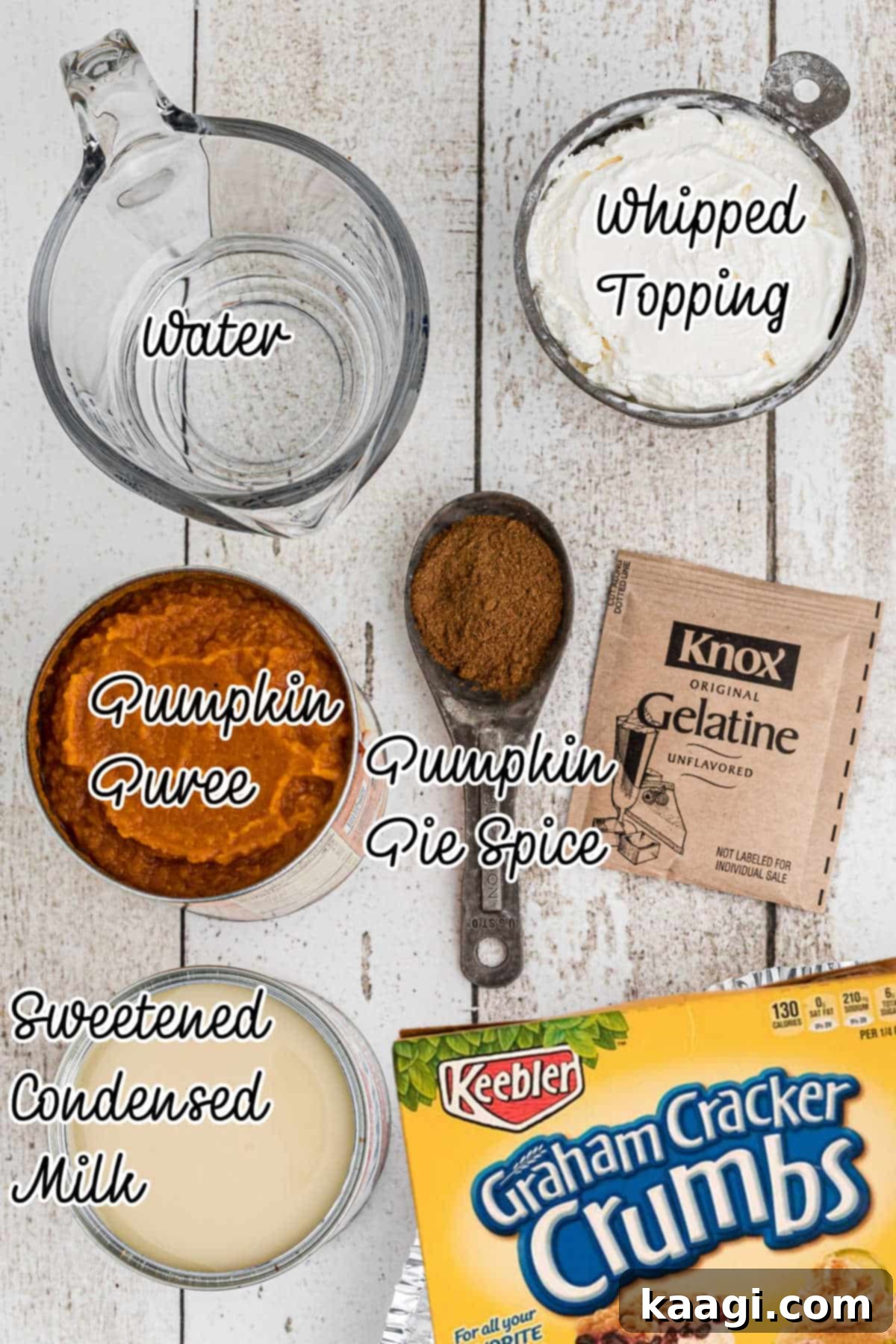 No bake mini pumpkin pies ingredients all laid out with text overlay, showing graham cracker crumbs, pumpkin puree, sweetened condensed milk, pumpkin pie spice, gelatin, water, and whipped topping.