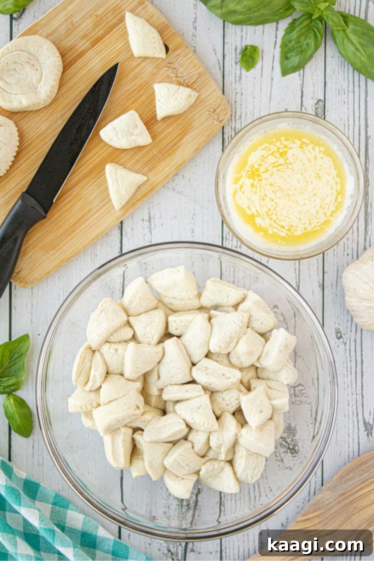 A bowl full of cut refrigerated biscuits, ready for mixing.