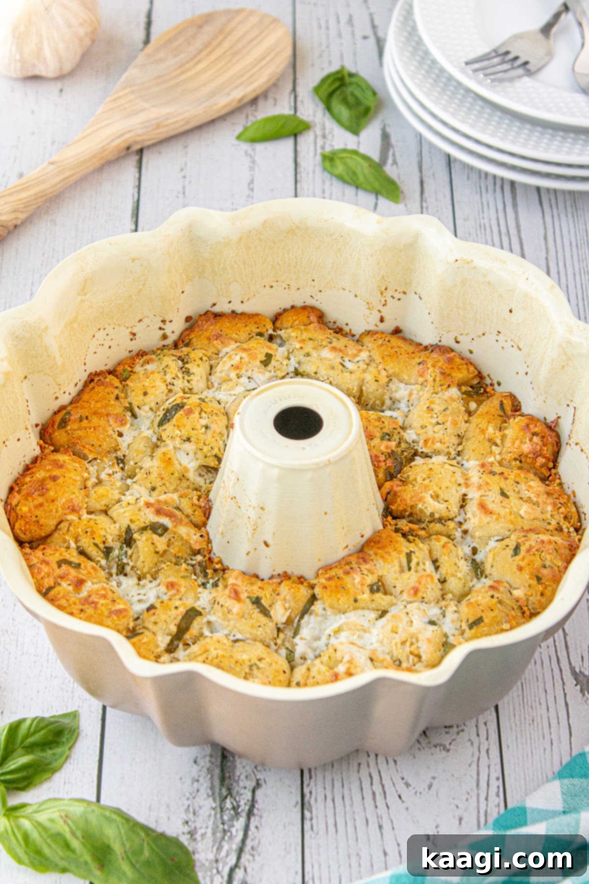 A bundt pan filled with cooked, golden-brown monkey bread, fresh out of the oven.