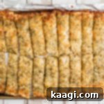 Mastering Little Caesars Cheesy Bread at Home 6 An overhead shot of a pan full of homemade Little Caesars Italian cheese bread recipe, golden and delicious.