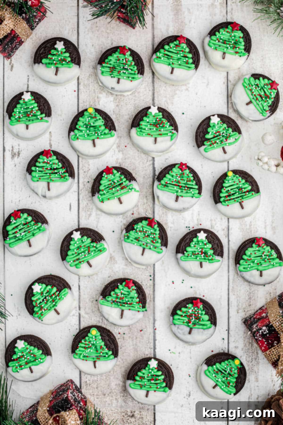 Festive Oreo Delights 4 Overhead shot of a lot of perfectly decorated Christmas Oreo cookies with green trees and colorful sprinkles arranged neatly.