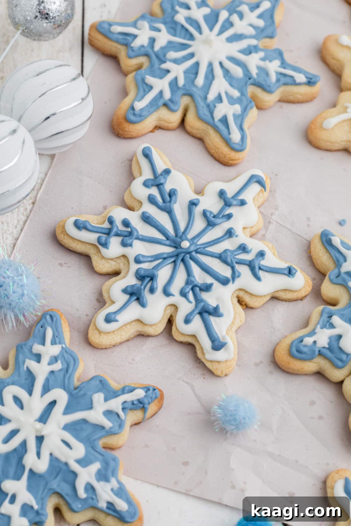 White and blue snowflake cookies with intricate designs.