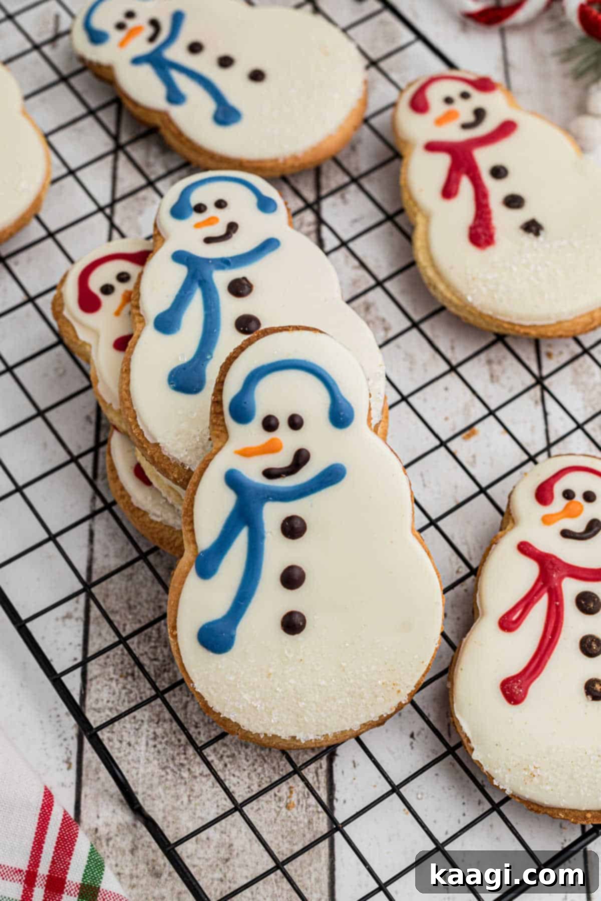 Starbucks snowman cookies up front in a stack on a cooling rack.