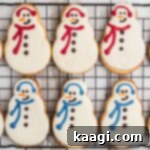 Copycat Starbucks snowman cookies lined up on a cooling rack.