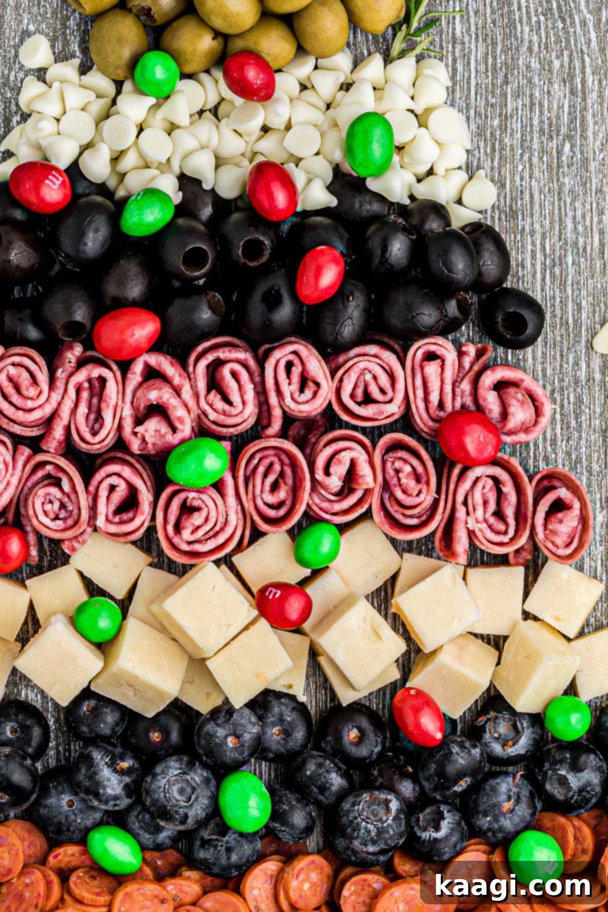 Close-up shot detailing the assembly and intricate arrangement of a Christmas Charcuterie Board.