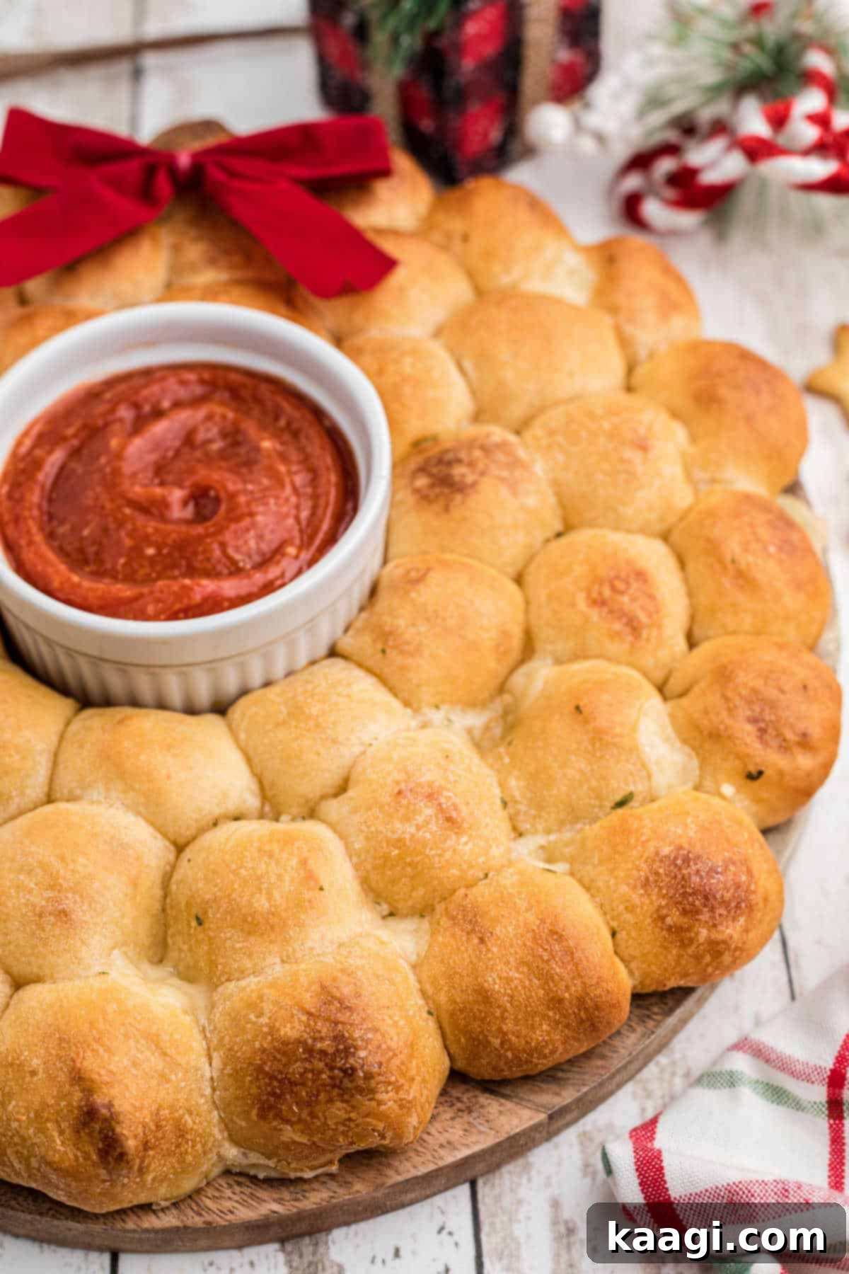 Christmas pull apart bread wreath, close up from the side, showcasing its delicious, cheesy interior.