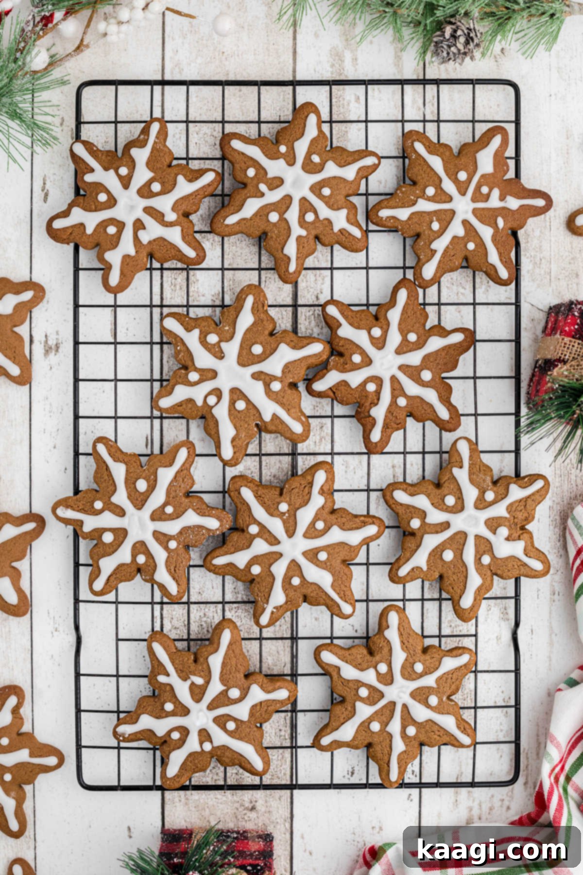 Overhead full on shot of a wire rack filled with gingerbread snowflake cookies.