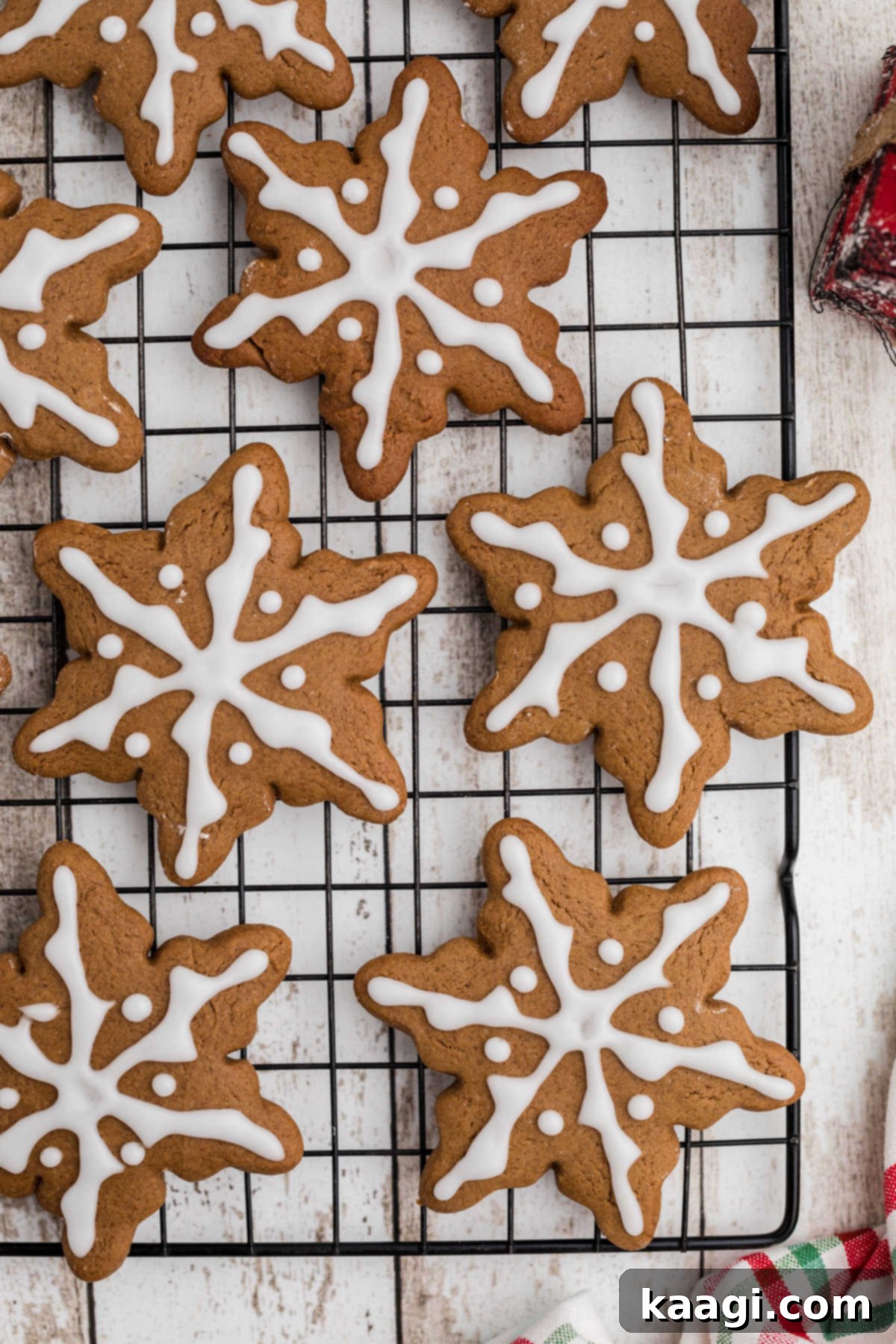 Overhead shot of a wire rack full of snowflake gingerbread cookies.