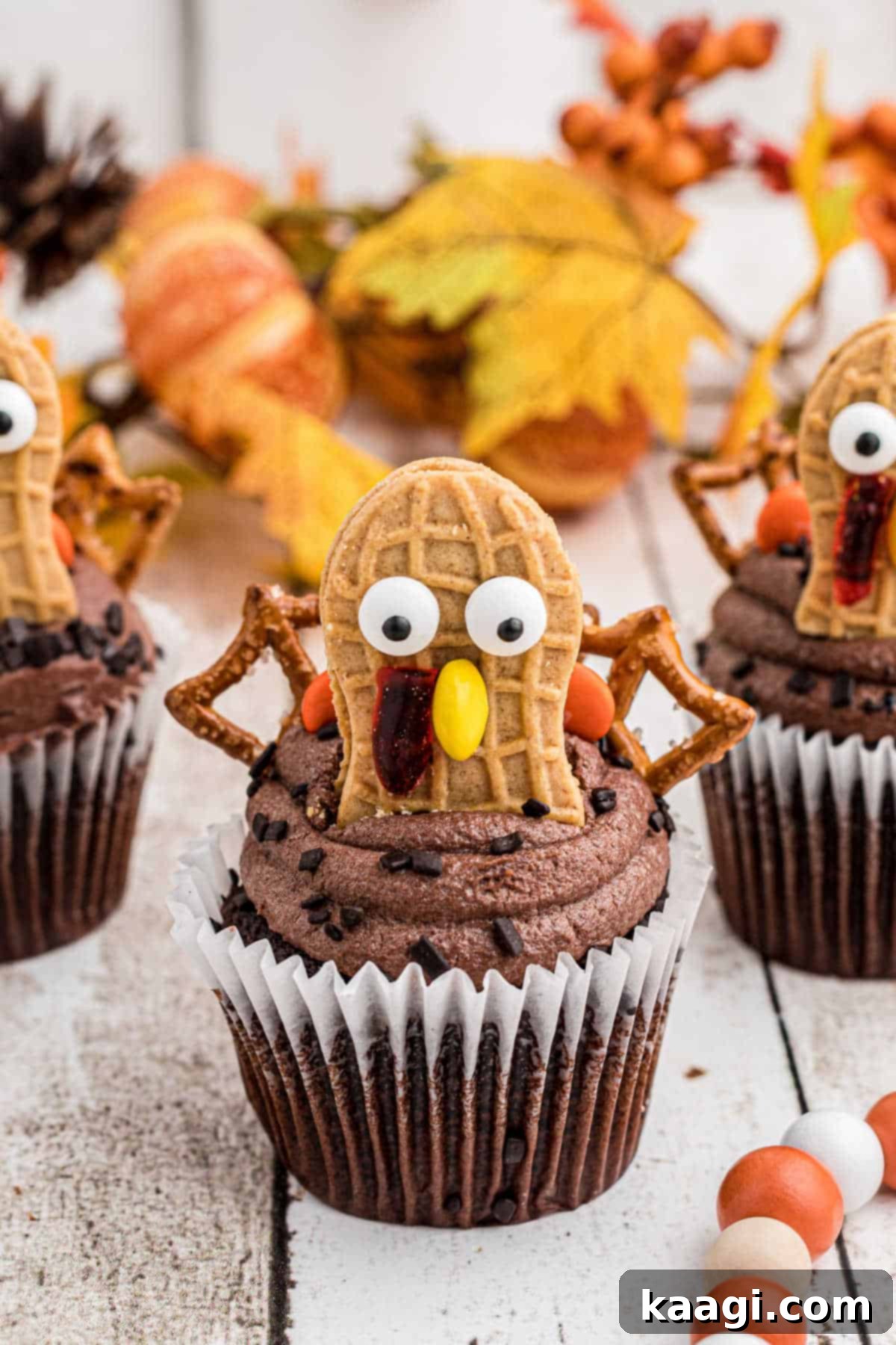 Thanksgiving Peanut Butter Turkeys 2 Festive Nutter Butter Turkey Cupcakes, perfect for a Thanksgiving dessert spread, showcasing vibrant candy details and a Nutter Butter cookie head.