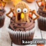 Thanksgiving Peanut Butter Turkeys 6 A close up of a turkey cupcake made with Nutter Butter cookies, showing its candy eyes and pretzel tail.
