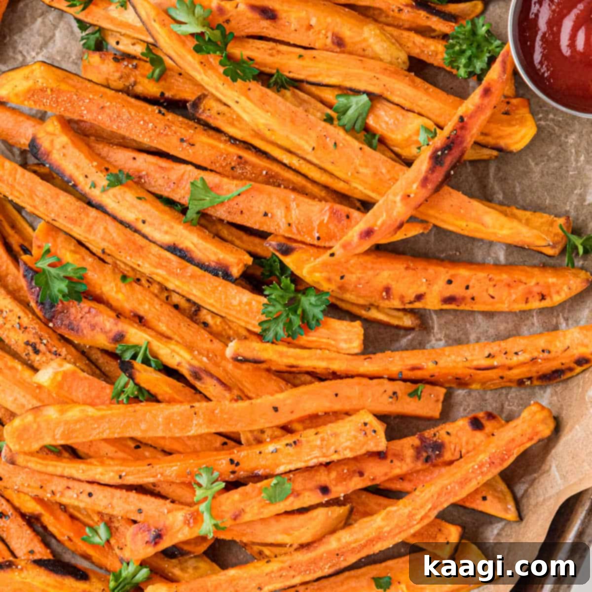 Close up of perfectly crispy sweet potatoes, seasoned and ready to eat.