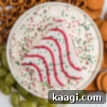 Sparkling Christmas Tree Dip 9 Overhead shot of Christmas Tree Dip with a Little Debbie Christmas Tree on top, garnished with sprinkles.