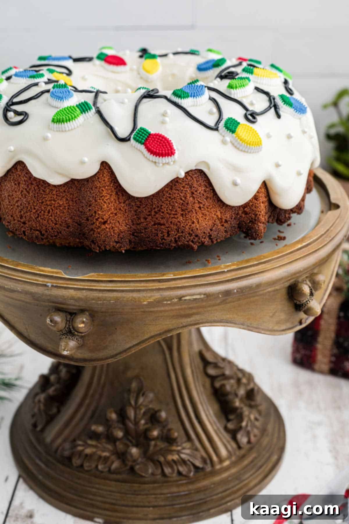 Holiday Bundt Bliss 2 Side view of a beautifully decorated Christmas Bundt cake with festive sprinkles and icing, standing elegantly on a cake stand.