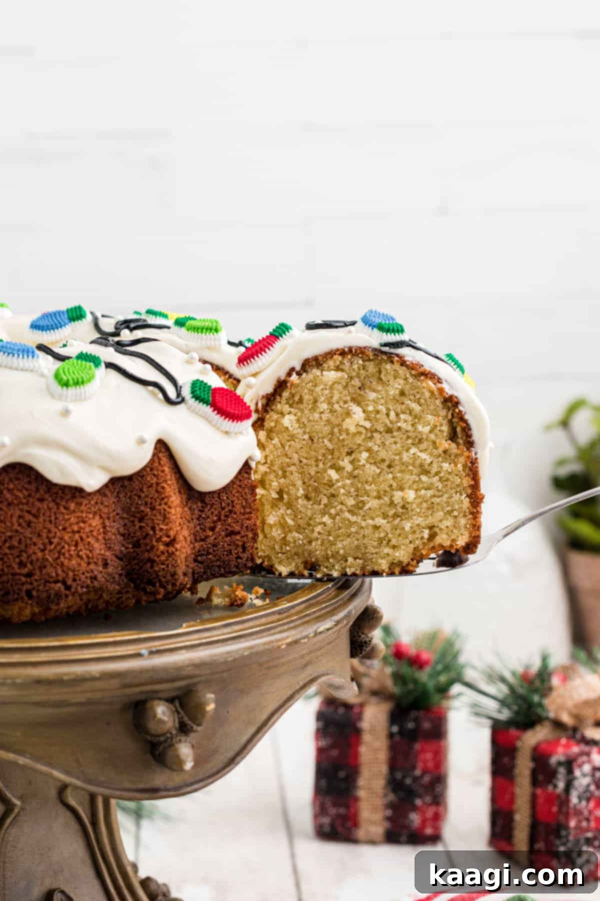 Holiday Bundt Bliss 7 A slice of Christmas bundt cake being removed from the main cake with a cake server.