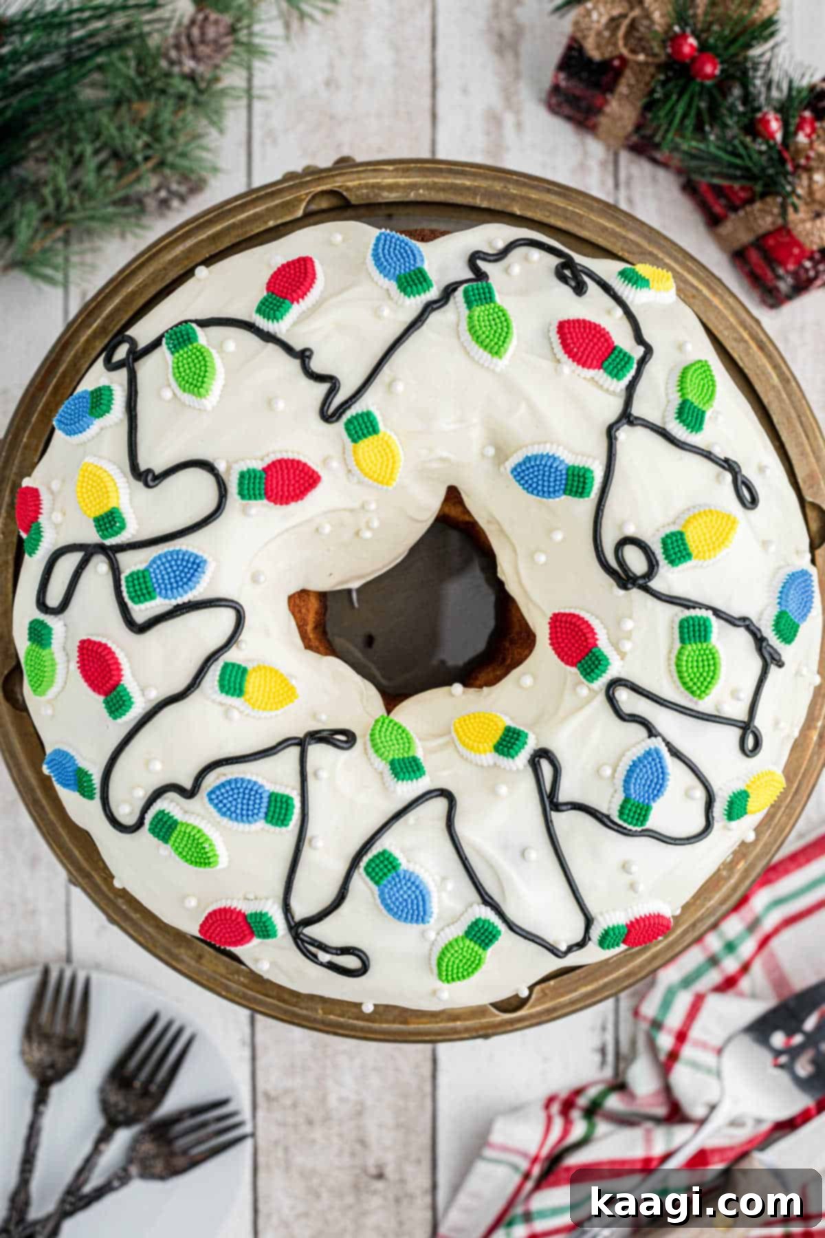 Holiday Bundt Bliss 4 Overhead view of a Christmas Bundt cake decorated with vibrant edible Christmas light decorations and pearl sprinkles.