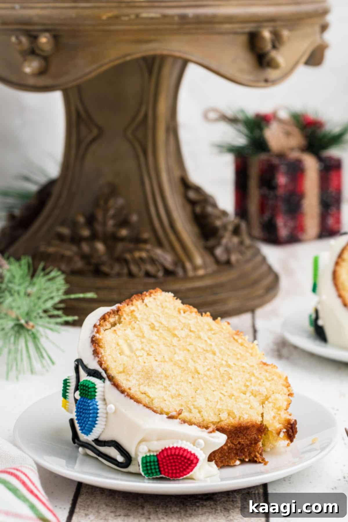 Holiday Bundt Bliss 5 A perfectly sliced piece of Christmas Bundt Cake presented on a plate, showing its moist texture and delicious frosting.