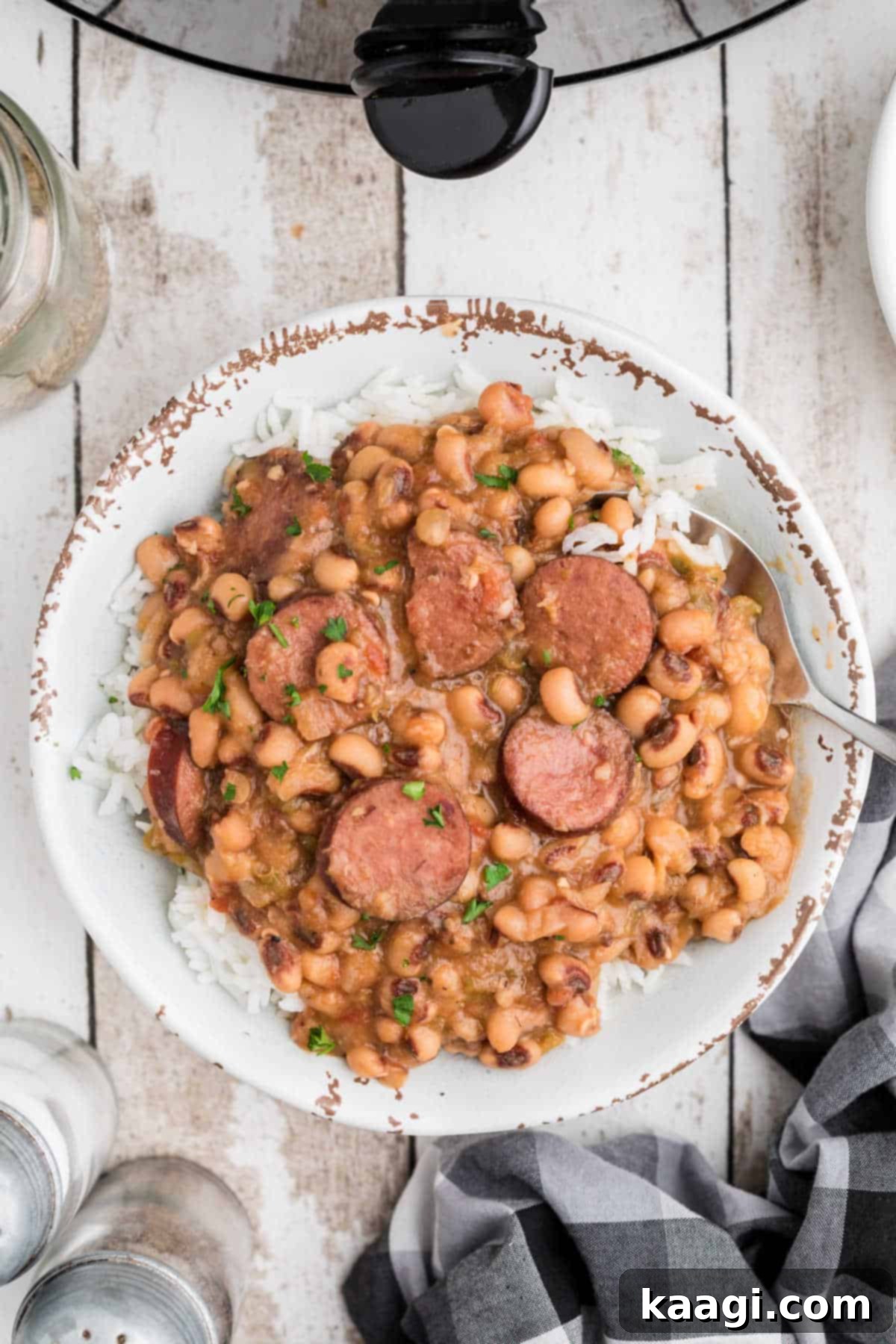Easy Slow Cooker Hoppin John 5 A beautifully plated bowl of Slow Cooker Hoppin' John served over a bed of fluffy white rice, ready to be enjoyed.