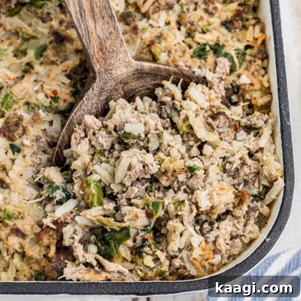 Close up of the corner of a casserole dish of Cajun rice dressing.