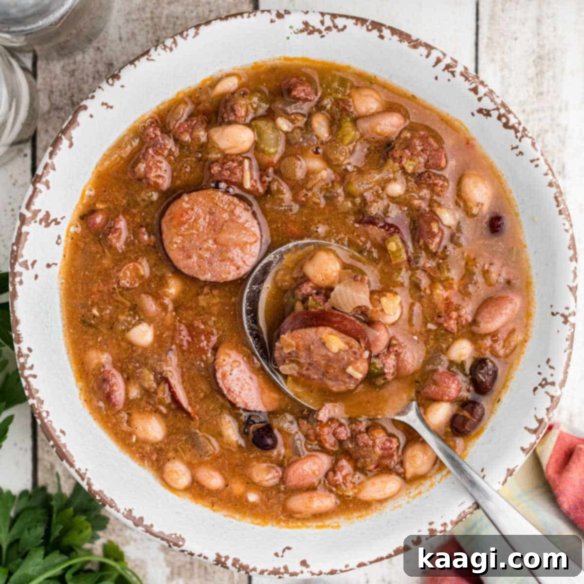 overhead shot of a bowl of Cajun 15 bean soup with a spoon digging in.