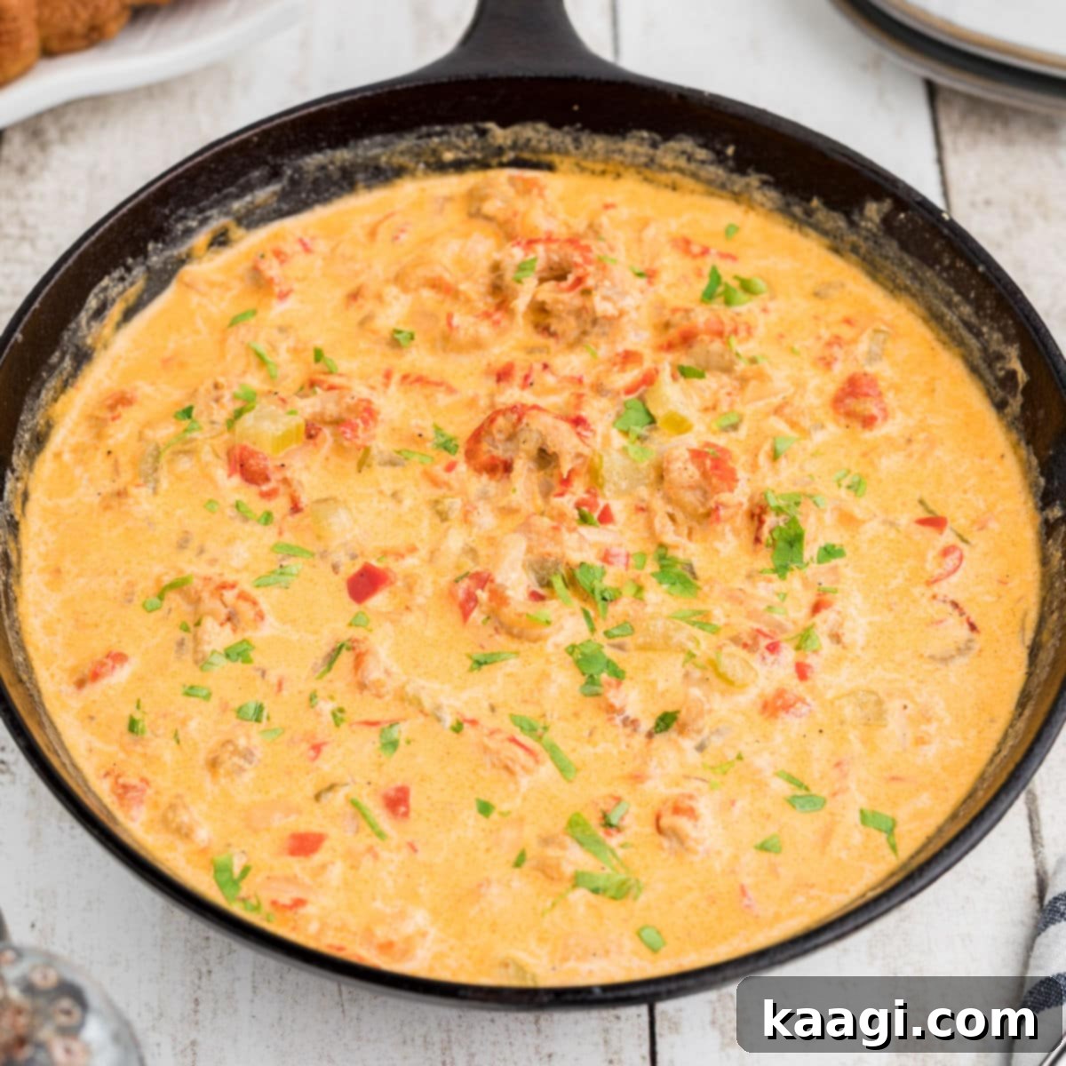 Side view of a skillet full of crawfish sauce.