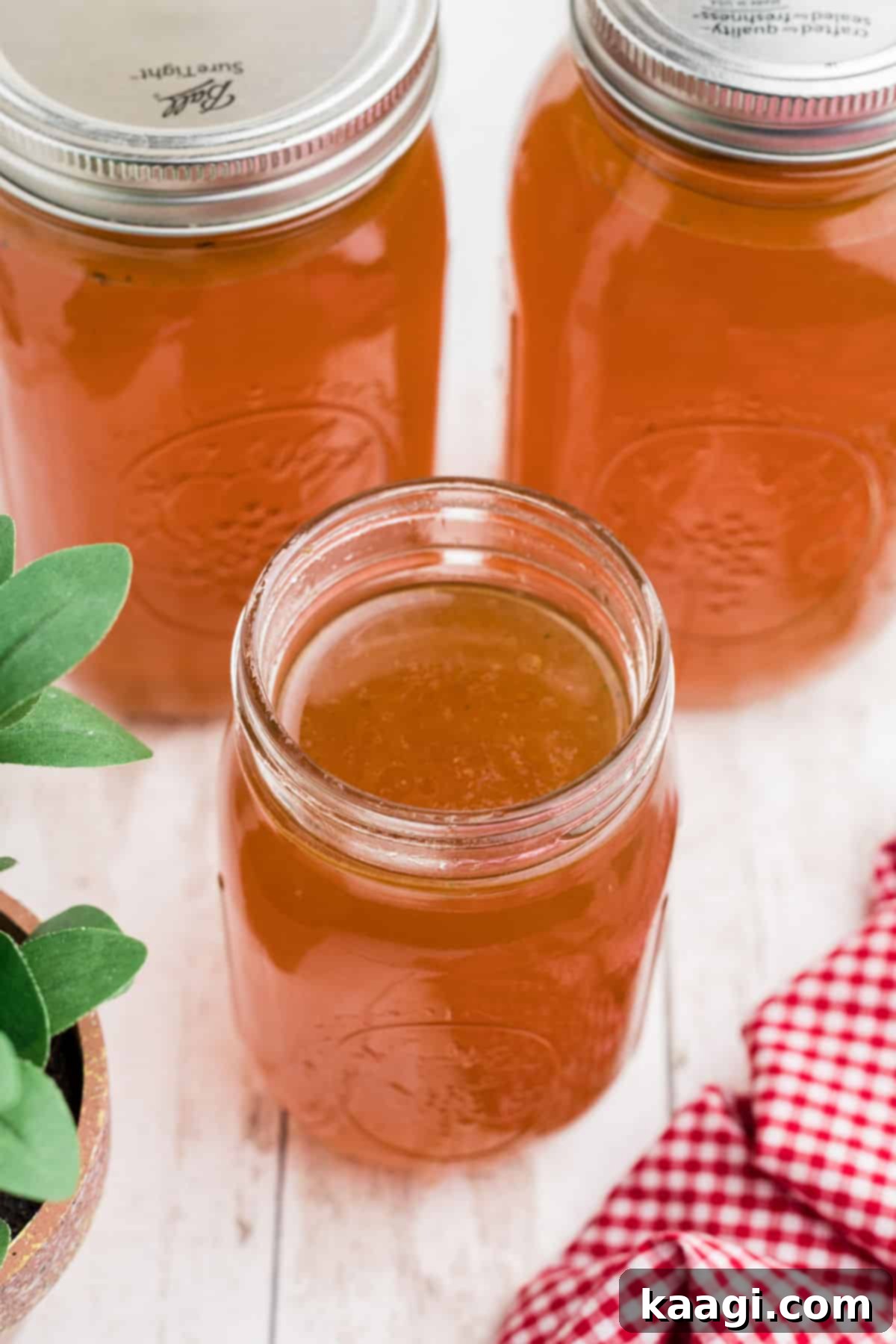 Another overhead shot of an open mason jar of Rotisserie Chicken Bone Broth, ready for use.