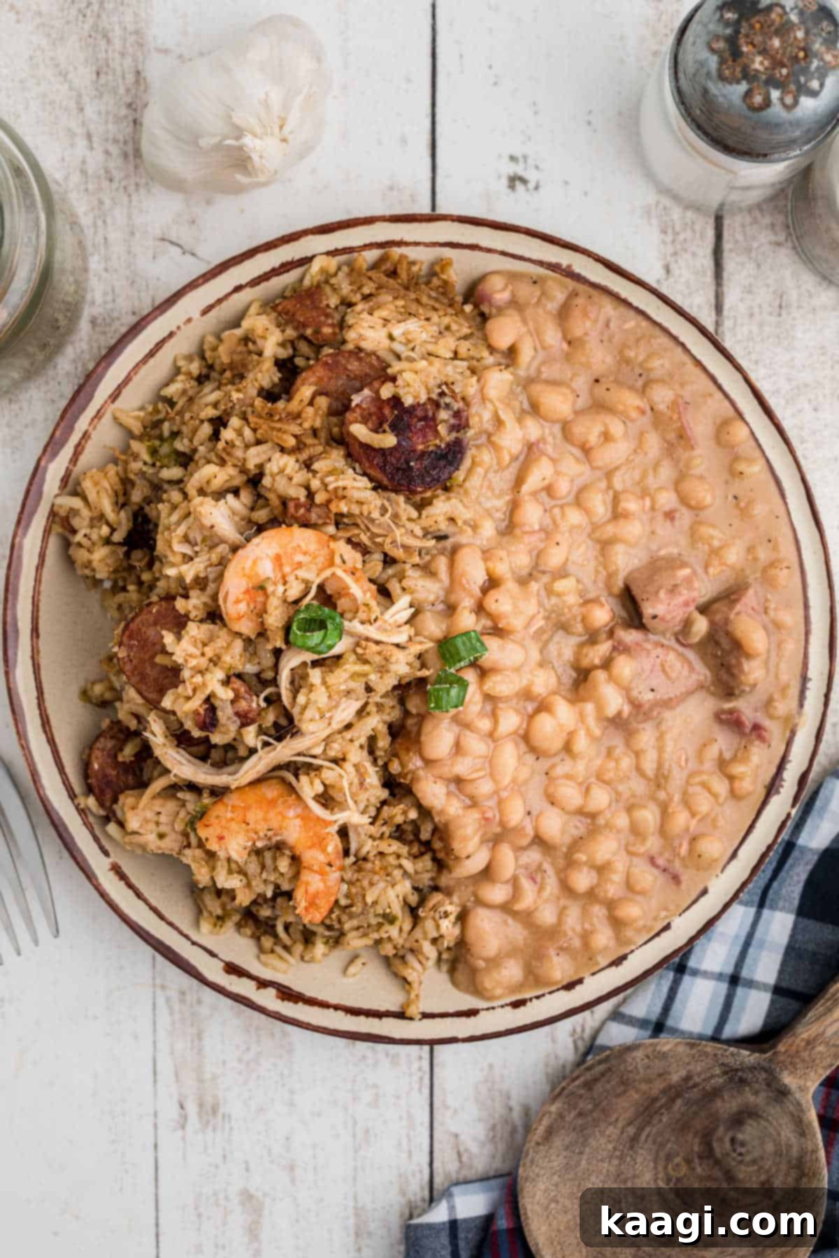 A dished out plate of Cajun Jambalaya with some white beans on the side, ready to eat.