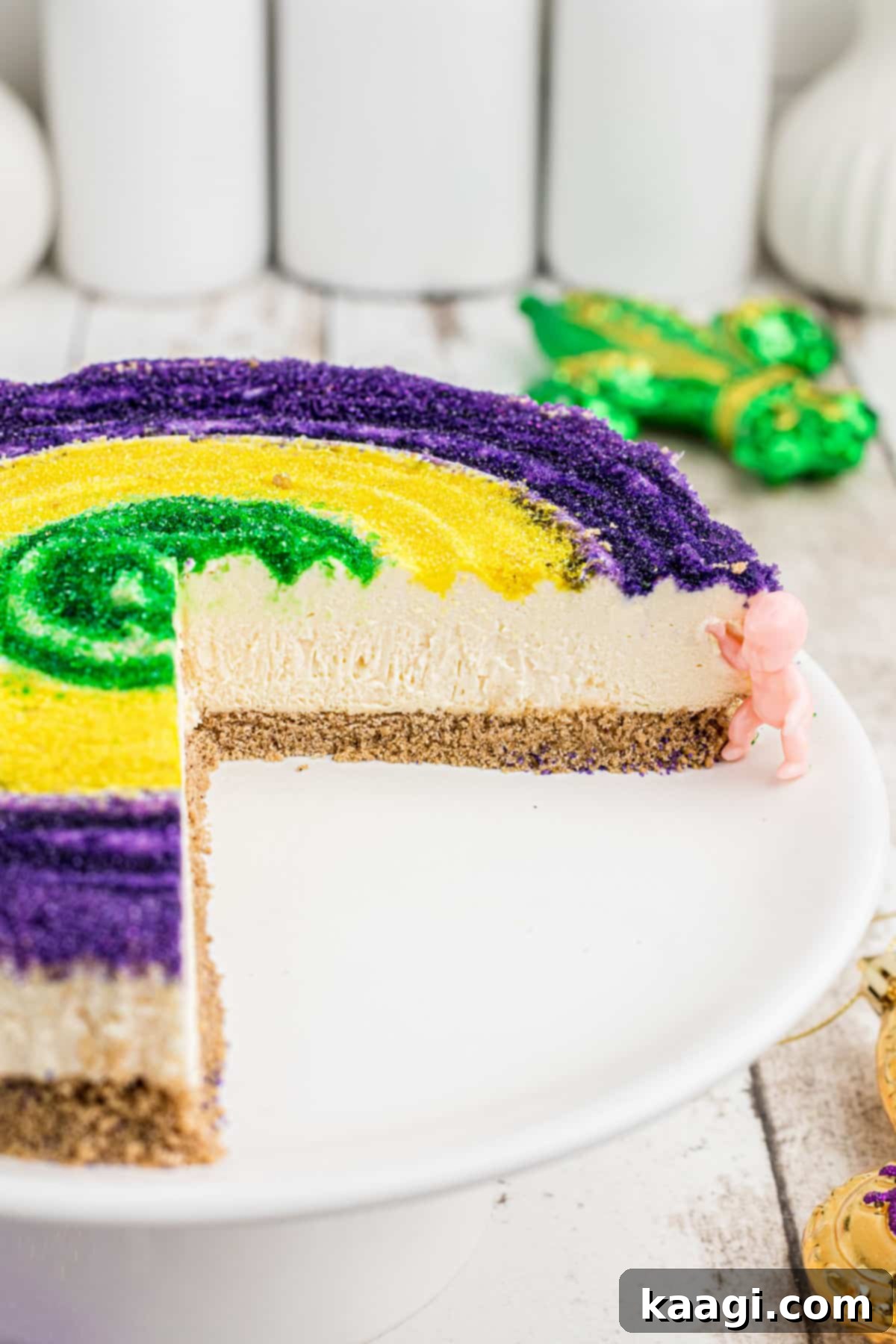 Festive Mardi Gras Cheesecake 4 A mardi gras cheesecake with slices missing.