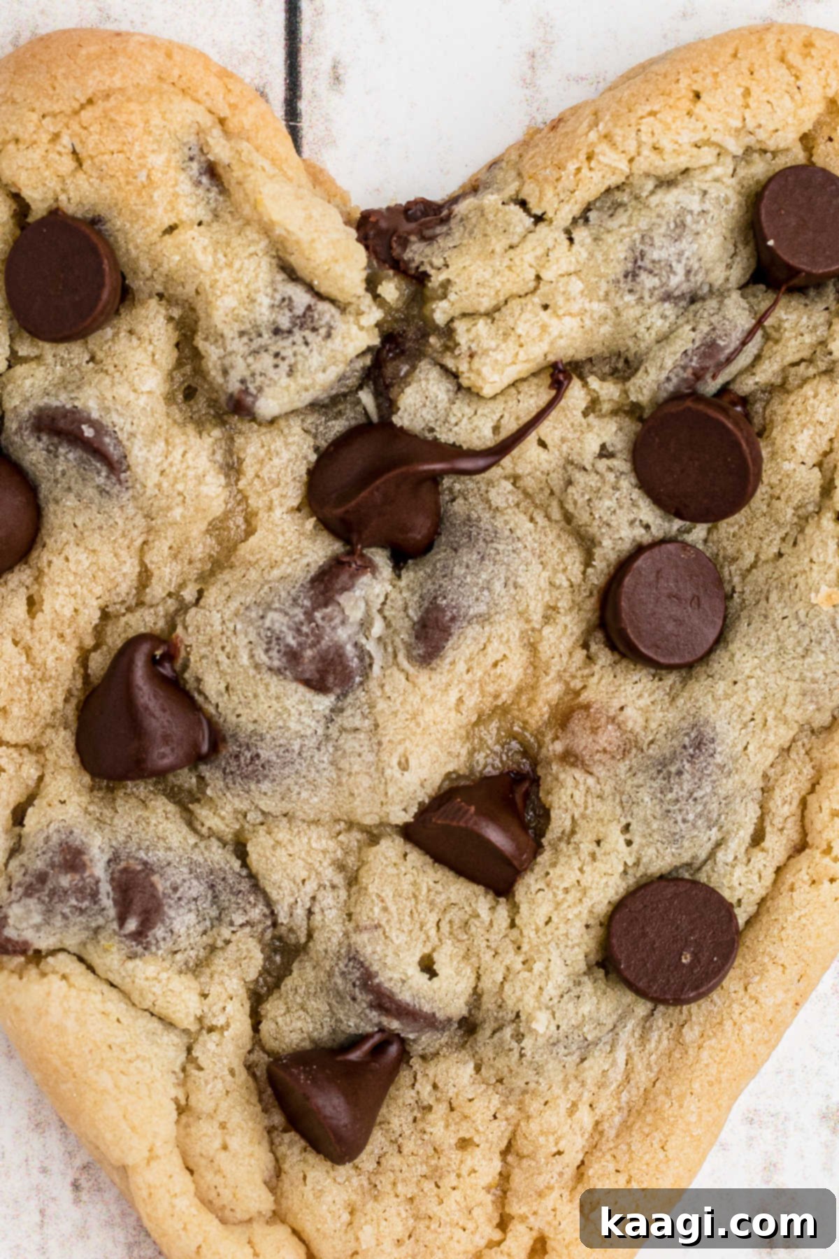 Very close up shot of a heart shaped chocolate chip cookie.