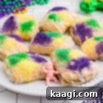 Little squares of King Cake Bites, an image cropped square, showcasing the vibrant glaze and sprinkles.