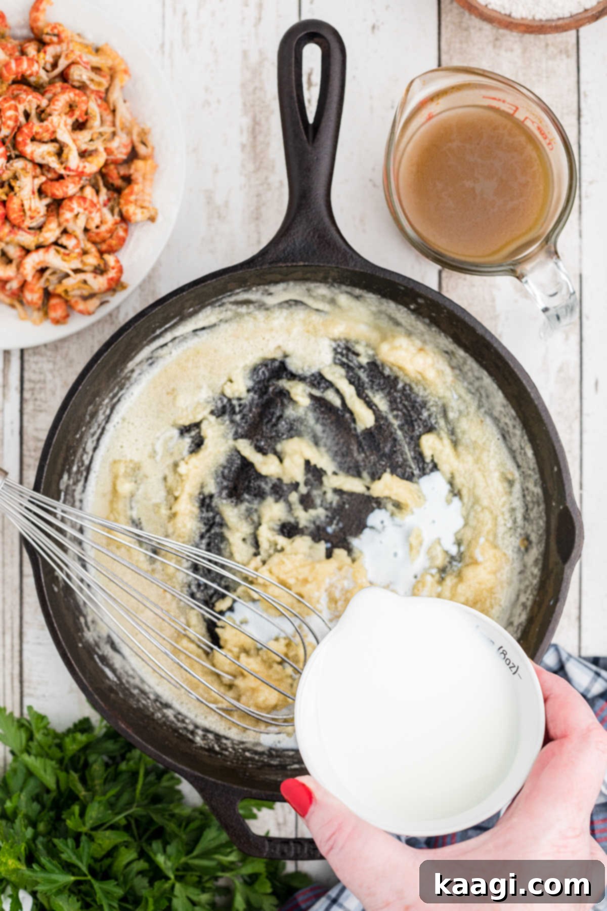 Milk being slowly poured into a black skillet.