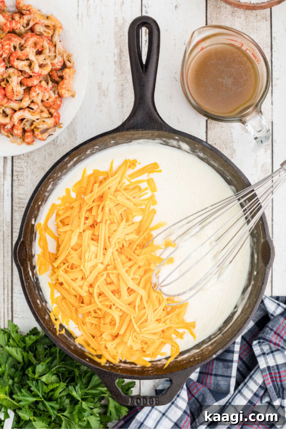 Grated cheese being added to black skillet.