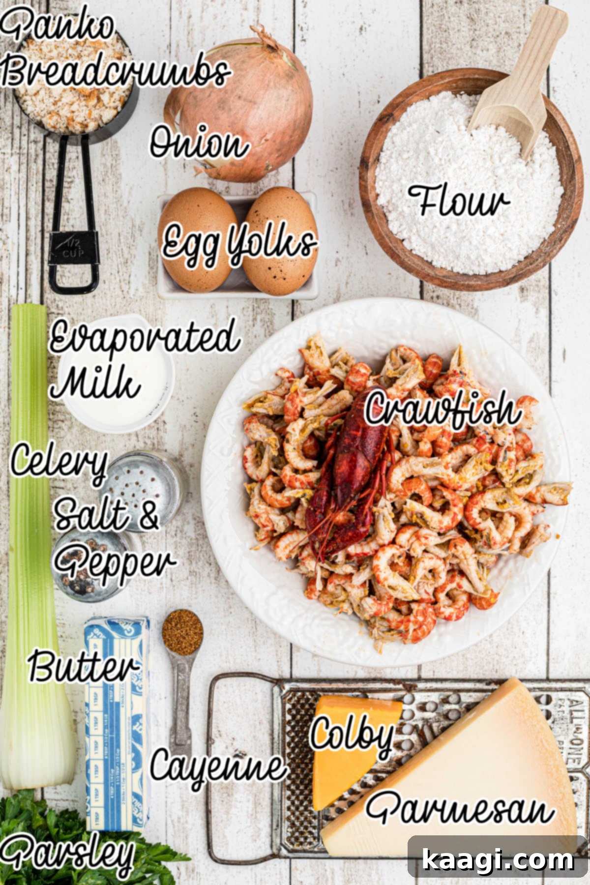 Ingredients needed to make a crawfish au gratin, with text overlay, including butter, onions, celery, flour, evaporated milk, egg yolks, various seasonings, Colby cheese, crawfish tails, panko, and parmesan.